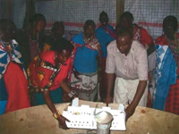 The women listen intently to the expert of the care and handling of the kukus.